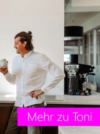 Toni, Mitgründer von ATHEM, entspannt mit einer Tasse Kaffee in der Hand in den Büroräumen.