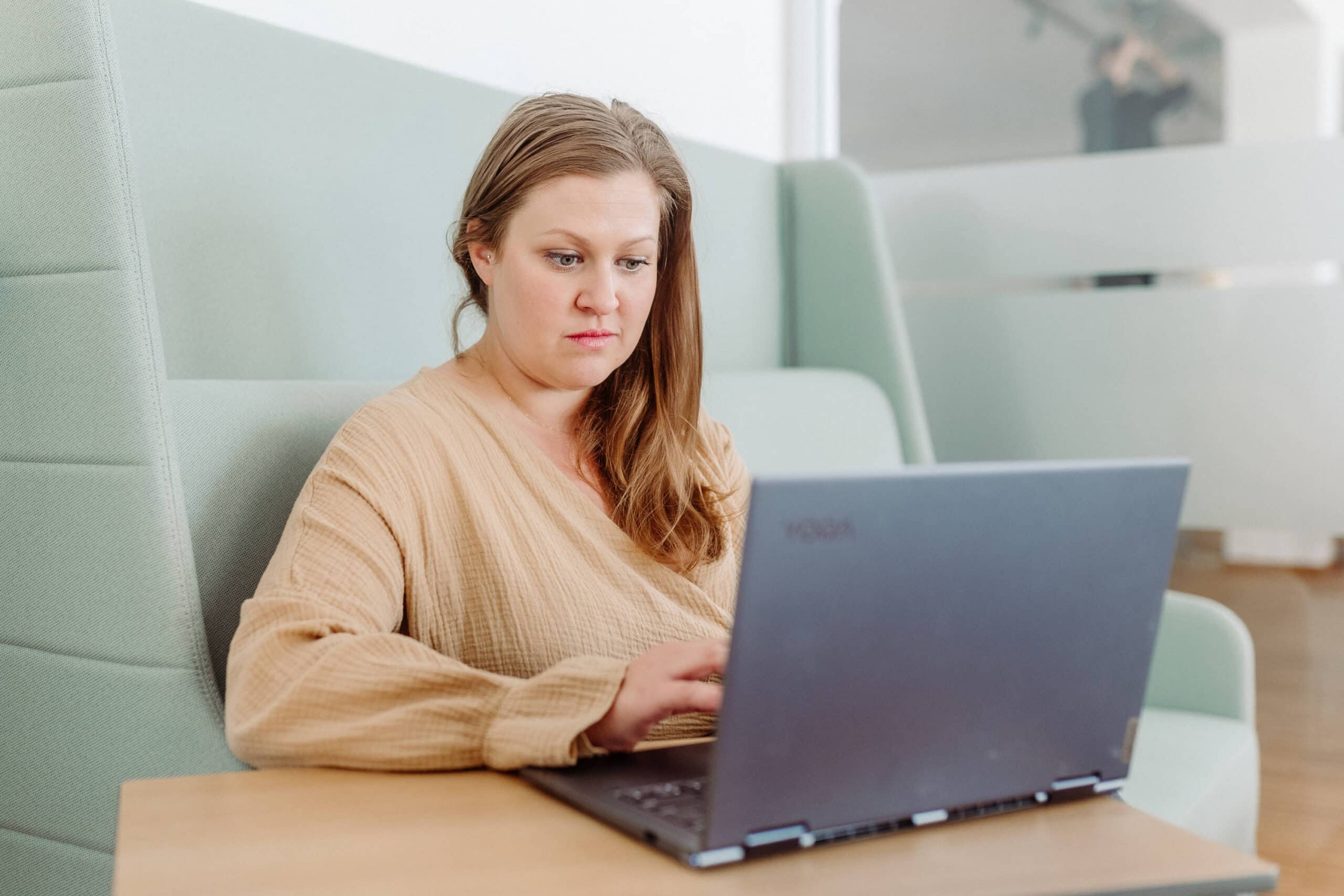 Karin arbeitet konzentriert am Laptop.