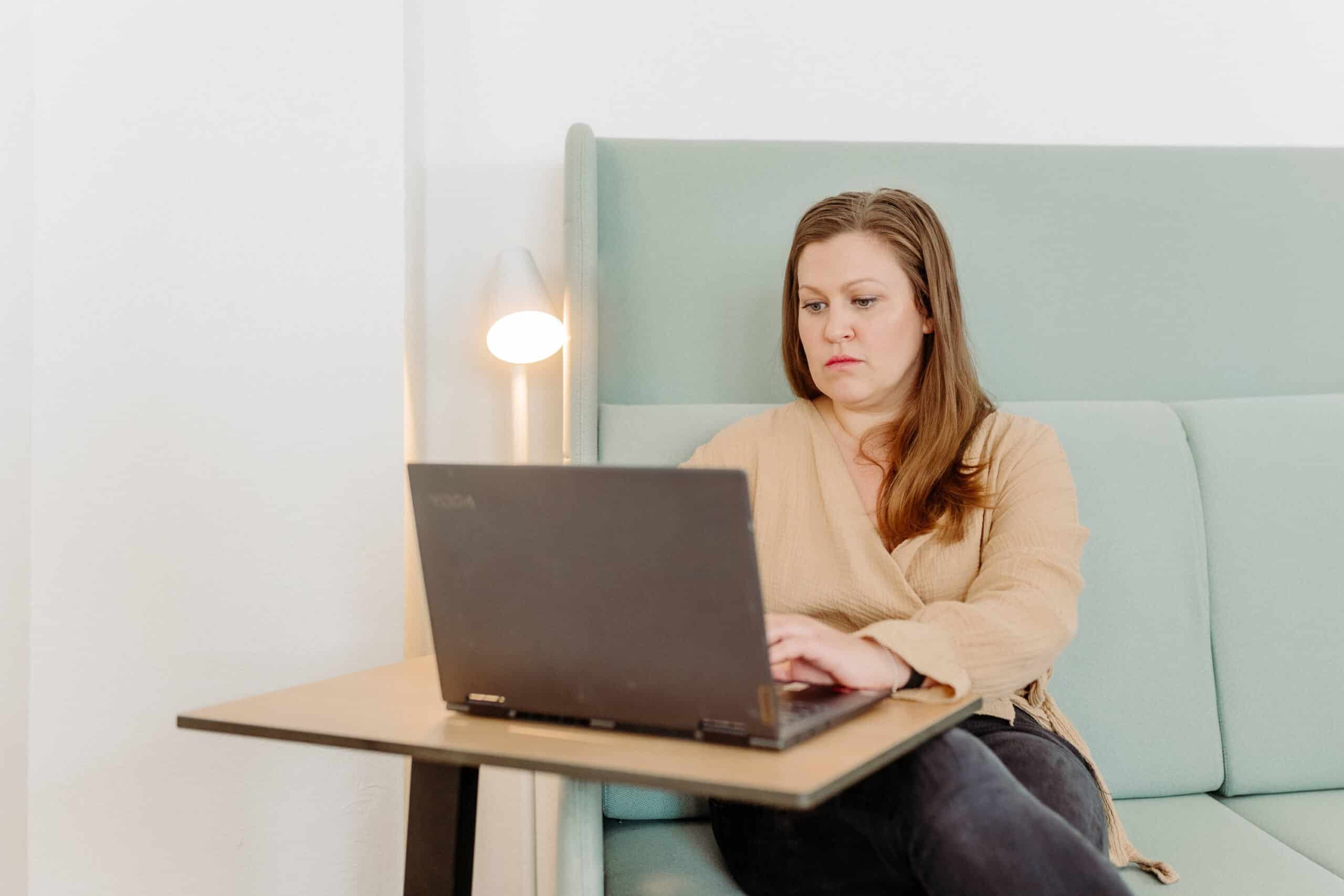 Karin arbeitet konzentriert am Laptop.